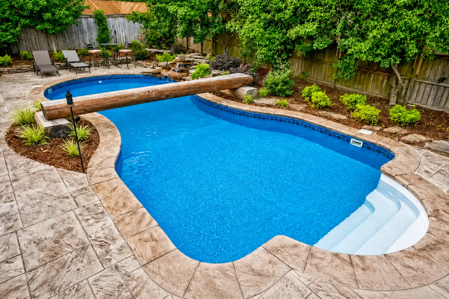 Vinyl pool with sun shelf and stamped concrete patio in Arkansas